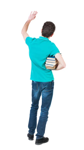 Man carries heavy pile of books — 스톡 사진