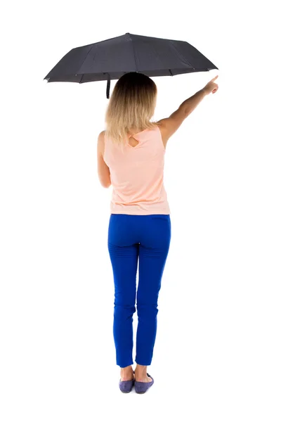 Pointing  woman  under an umbrella — Zdjęcie stockowe