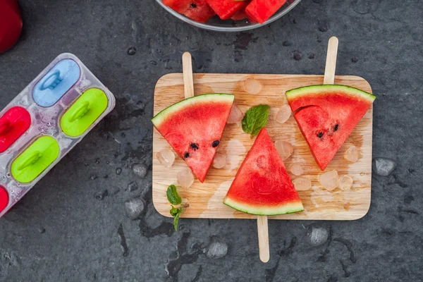 Watermelon slices on wooden stick with lime — Stock Photo, Image