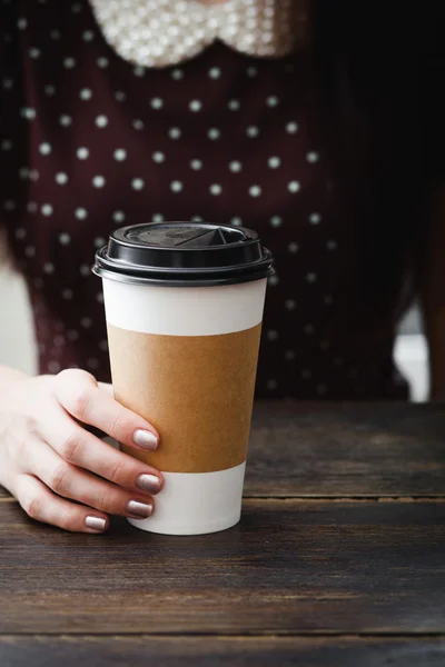 Coffee paper cup in the girl hands