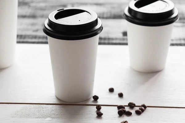 Paper coffee cup for logo, wooden table — Stock Photo, Image