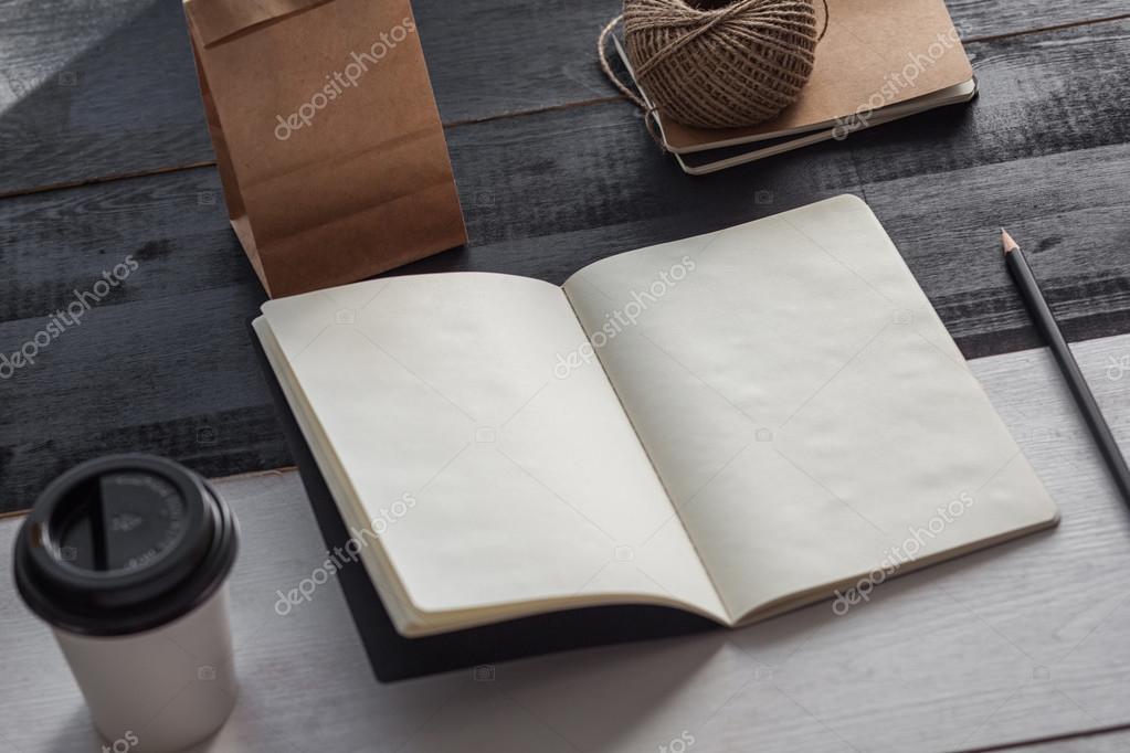 Sketchbook with coffee concept on wooden table, vintage style