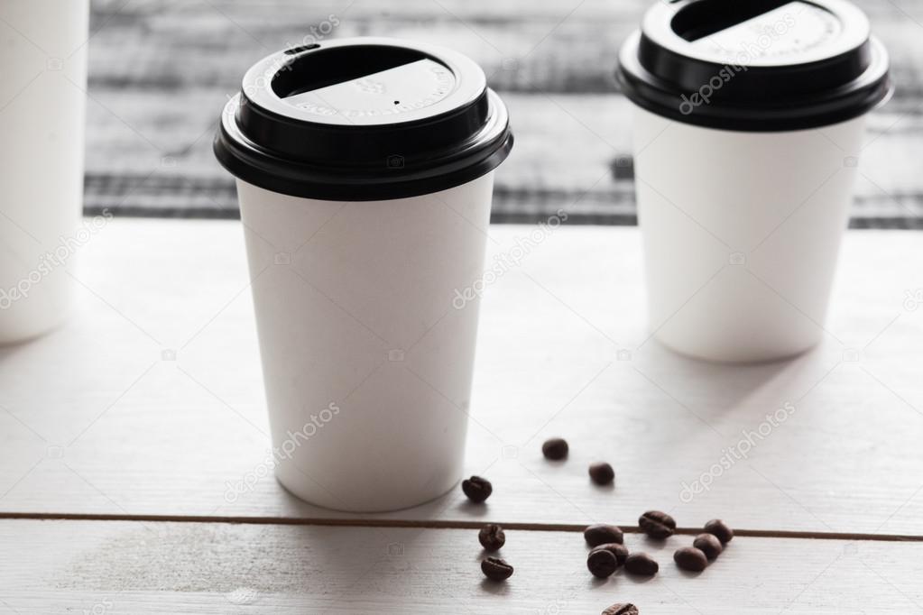 Paper coffee cup for logo, wooden table vintage style