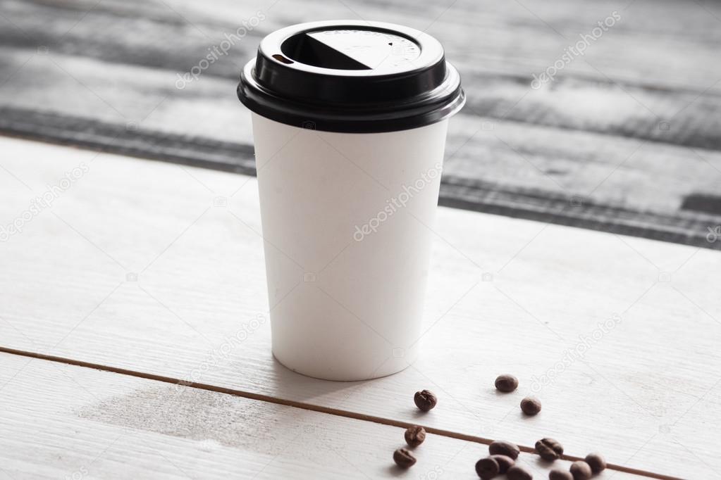 Paper coffee cup for logo, wooden table vintage style