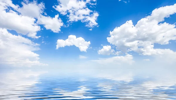Море и облачное голубое небо — стоковое фото