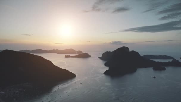 Sunrise silhouette of mountain island at sea port town. Aerial view of serene seascape at pier city — Stock Video