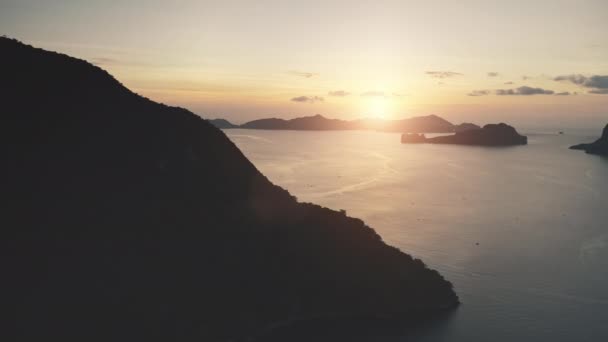 Sílhueta de ilha de montanha tropical na baía do oceano por do sol. Vista aérea pôr-do-sol luz em ninguém paisagem marinha — Vídeo de Stock