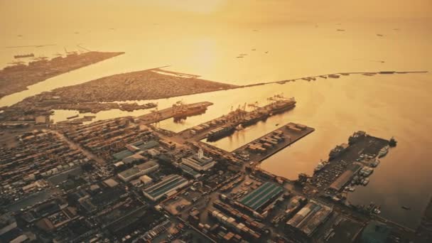 マリーナの海港の上に沈む夕日。街と空中の街並み、太陽が沈むドックの道路光 — ストック動画