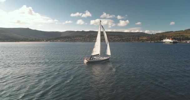 Langsom bevegelse av solens havgulf med seilende lystbåt. Refleksjon av sollys ved seilbåt på sjøbukta – stockvideo