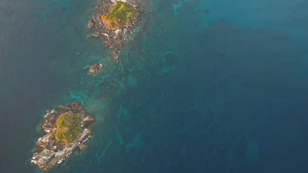 Nahoře na skalnatých ostrovech v oceánu. Nikdo nežije v mořském zálivu. Zelené tropické rostliny — Stock fotografie