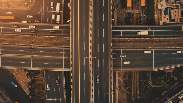 Sun at top down traffic cross road aerial. Urban transportation with cars, trucks, buses at sunlight — Stock Photo, Image