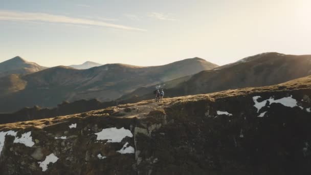 Τουρίστας στην κορυφή του βουνού κεραία. Άνθρωποι στο φθινοπωρινό τοπίο της φύσης. Χιόνι και καμμένο γρασίδι στο βουνό — Αρχείο Βίντεο