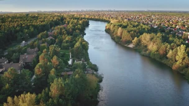 Grüner Wald am Flussufer. Herbstliche Naturlandschaft. Stadtbild am Bach. Gebäude in der Innenstadt — Stockvideo