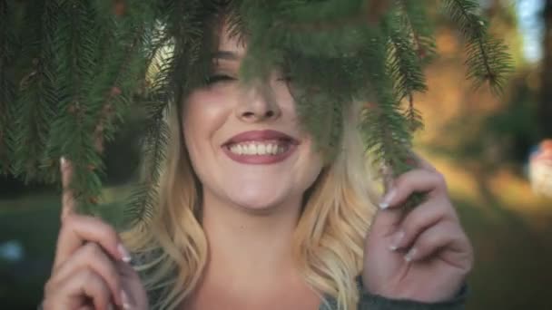 Pretty Blonde Girl Fool Around Fir Tree Branch — Stok Video