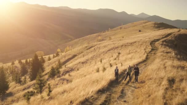 Touristen an getrocknetem Gras, Bäume in der Luft. Bergketten bei Sonnenuntergang. Sonnenuntergang. Naturlandschaft — Stockvideo