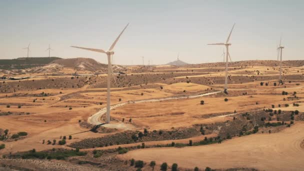 Ветроэлектростанции на желтом песке земли. Панорама вращения ветряной мельницы. Зеленый источник энергии. — стоковое видео
