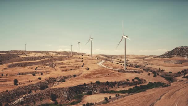 Modern wind turbines rotate produce alternative energy electricity in desert landscape area — Stock Video