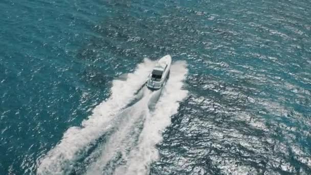 Śledzenie biały jacht motorowy żaglówka w wodzie morskiej niebieski w pobliżu wybrzeża Cypr kurort Ayia Napa — Wideo stockowe