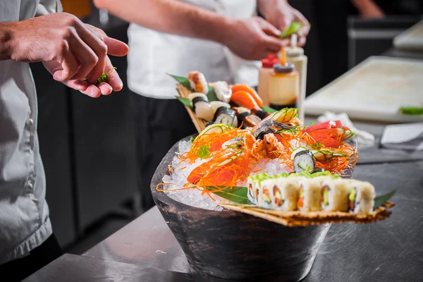 Male cooks preparing sushi — Stock Photo, Image