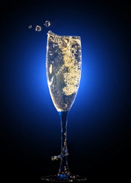 Glass of champagne with splashes — Stock Photo, Image