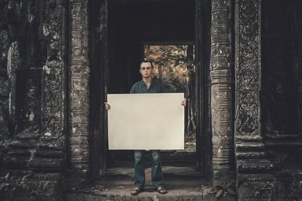 Young man holding placard — Stock Photo, Image