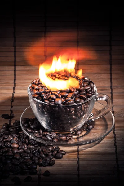 Steaming cup of coffee on fire — Stock Photo, Image