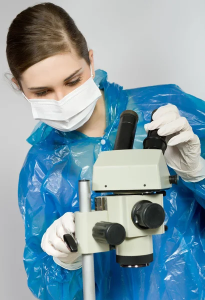 Ragazza che guarda attraverso un microscopio — Foto Stock