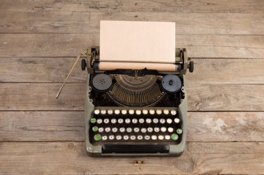 Vintage typewriter on the old wooden desk clipart