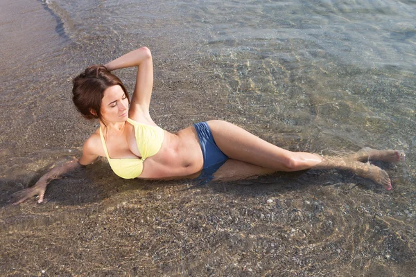 Young sexy woman in a swimsuit in the sea water — Stock Photo, Image