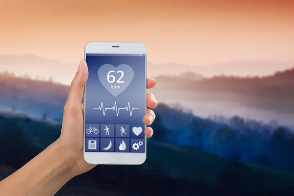 Health monitoring concept - special app on smartphone in a hand outdoors