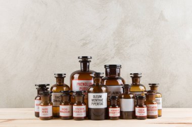 Retro pharmacy vintage pharmacy bottles on wooden board clipart
