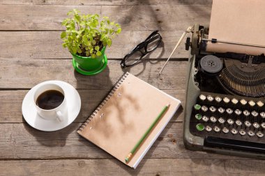 Vintage typewriter on the old wooden desk clipart