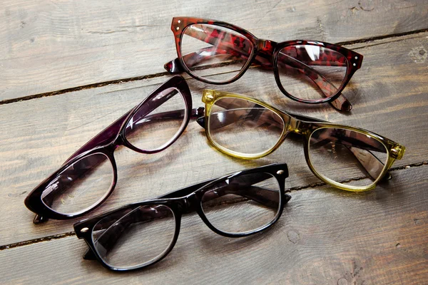 Set of reading glasses on wooden background — Stock Photo, Image