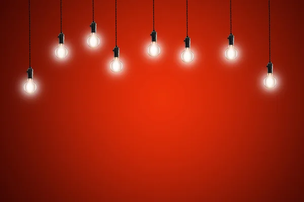 Idea concept - Vintage incandescent bulbs on red background — Stock Photo, Image
