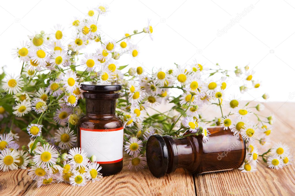 Alternative medicine concept - fragrant oil in a bottle with cam