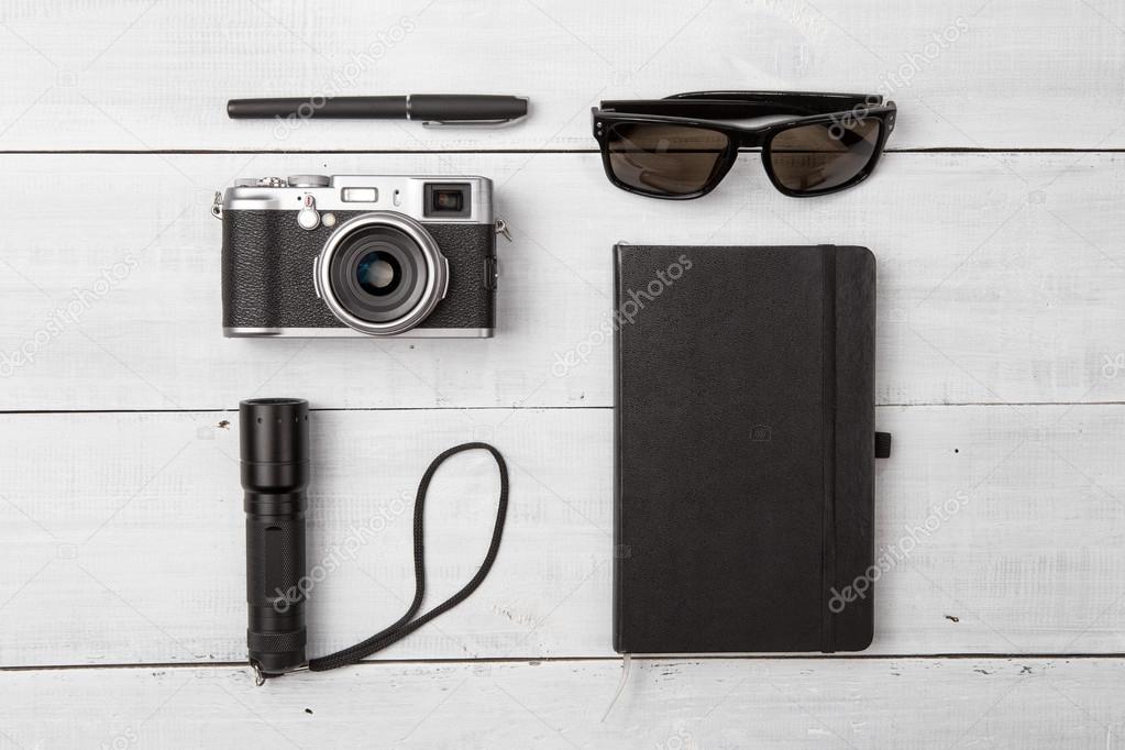 Set of camera and cool travel stuff on wooden table