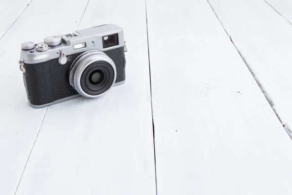 Retro style digital camera on wooden background — Stock Photo, Image