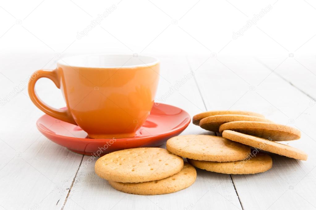 Cup of tea and biscuits on wooden background