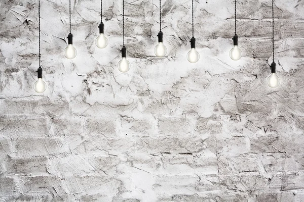 アイデア コンセプト - ヴィンテージ壁の背景に白熱電球 — ストック写真