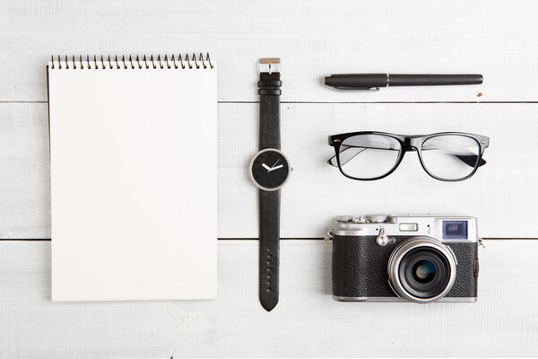 travel concept - set of camera, notepad, watch, glasses and pen