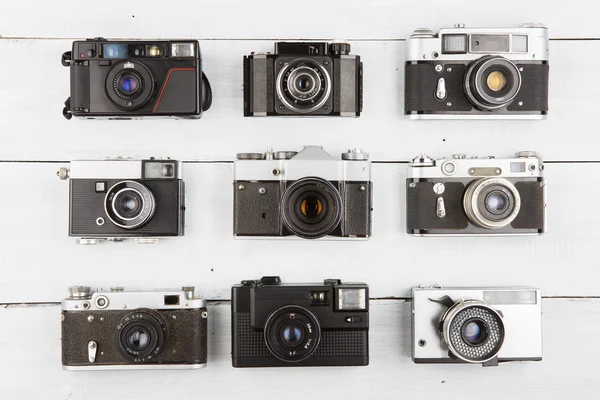 Set of vintage film cameras on wooden table — Stock Photo, Image