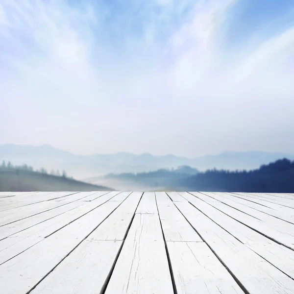 View on misty mountains from wooden terrace — Stock Photo, Image