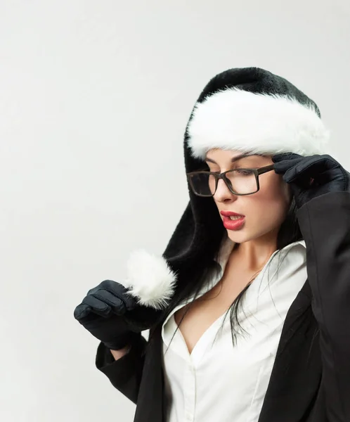 Portrait of a woman in a black business suit with glasses and a black Santa hat — Stock Photo, Image