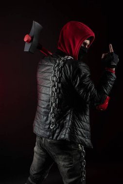 a man in a Balaclava and hoodies with an axe the image of a Protestant shows the middle finger clipart