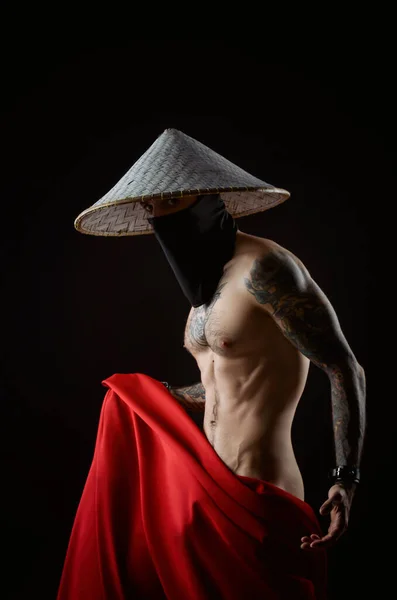 a naked slender samurai man in a red raincoat and an Asian hat