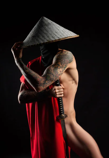 a naked slender man samurai in a red cape and an Asian hat with a tattooed katana