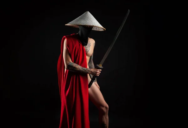 a naked slender man samurai in a red cape and an Asian hat with a tattooed katana