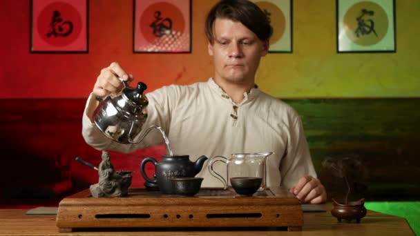 Un hombre prepara té PU-erh según las costumbres chinas tradicionales — Vídeo de stock