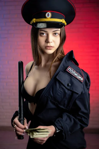 Sexy žena v ruské policejní uniformě s obuškem a penězi. Anglický překlad Policie — Stock fotografie