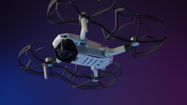 The smallest drone. unmanned aerial vehicle with blade protection and camera in flight in neon light . Russia — Stock Video